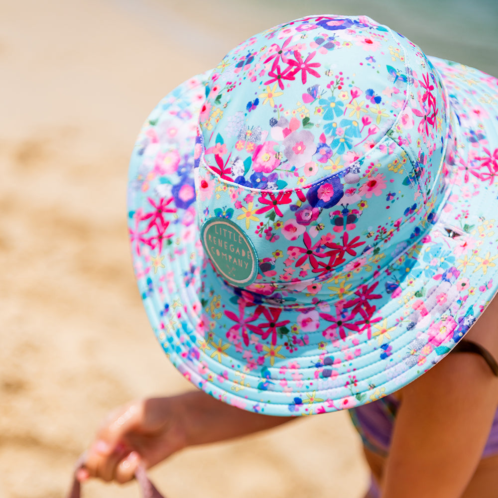 Child wearing a Little Renegade Swim Hat at the beach