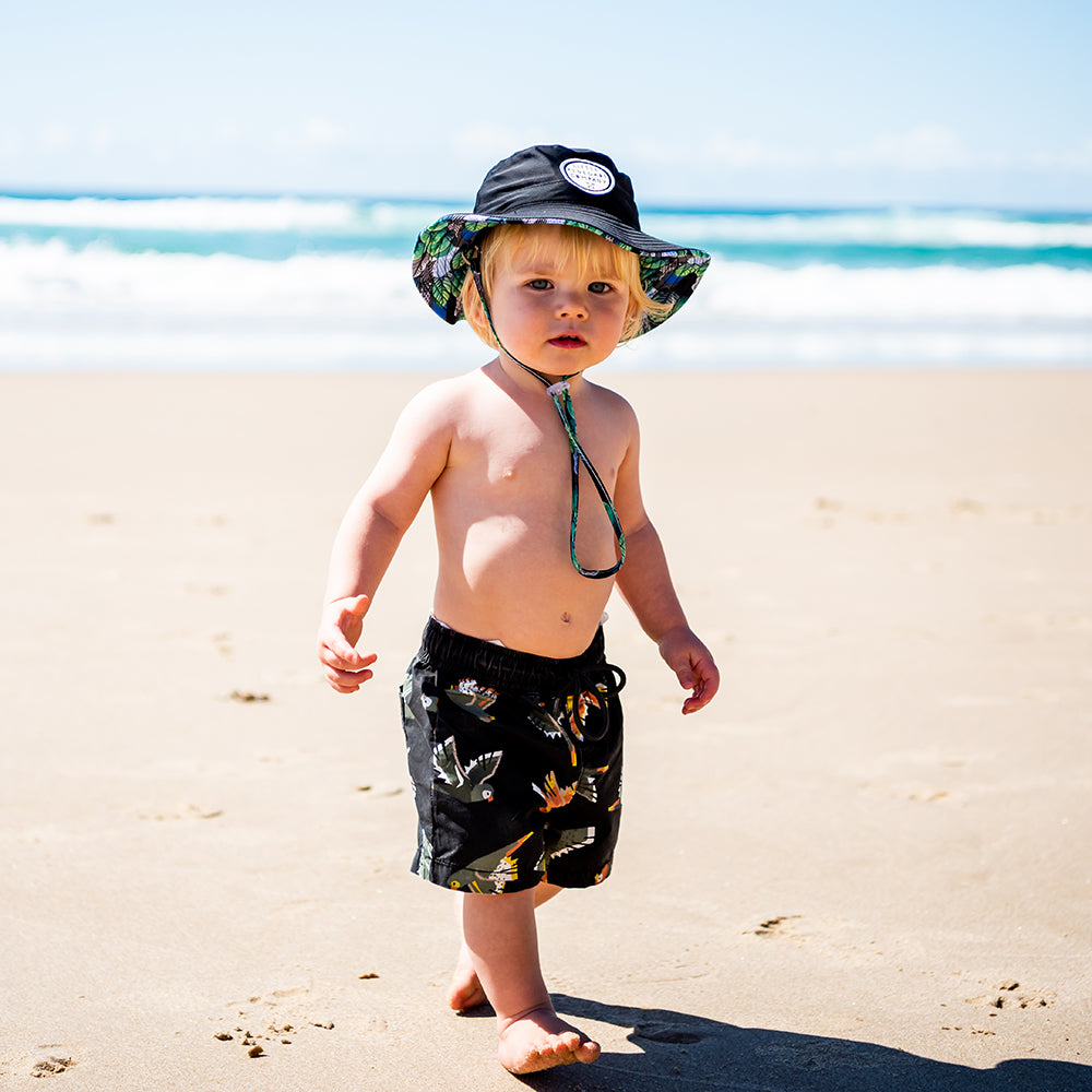 Child wearing a Little Renegade Swim Hat on a splash day