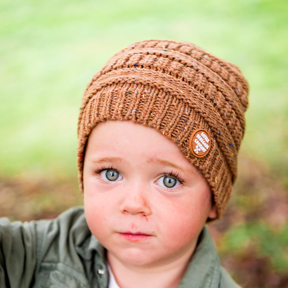 Child wearing the Mocha Byron Beanie outdoors