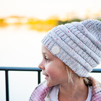 Side close-up of a child wearing the Speckle Byron Beanie outdoors