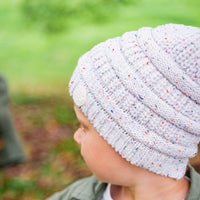Side view of a child wearing the Speckle Byron Beanie showing the textured knit