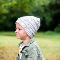 Child wearing the Speckle Byron Beanie in side profile outdoors