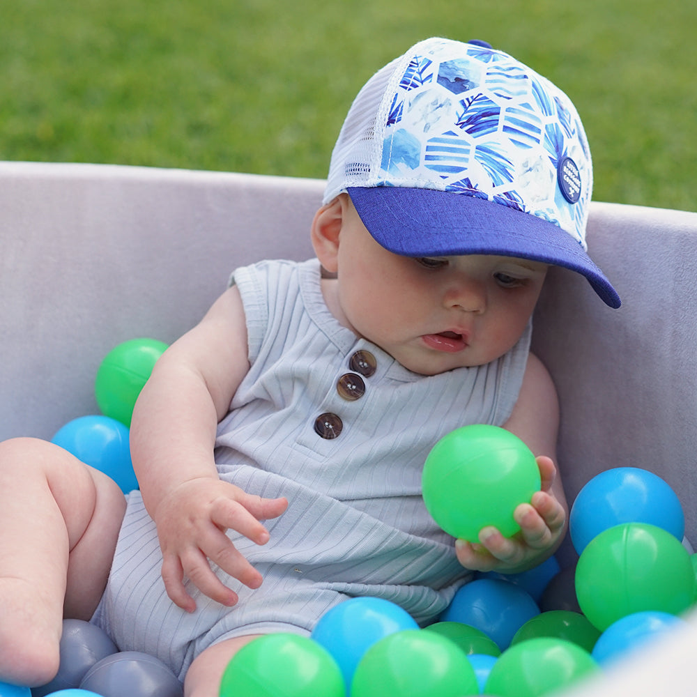 Child wearing the Azure Trucker Cap during an outdoor adventure