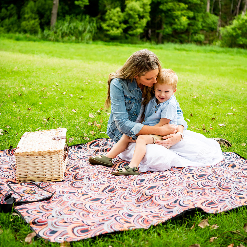Arizona Adventure Mat laid out on the grass with a picnic basket