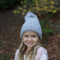 Girl wearing the Grey Aurora Beanie during an outdoor winter outing