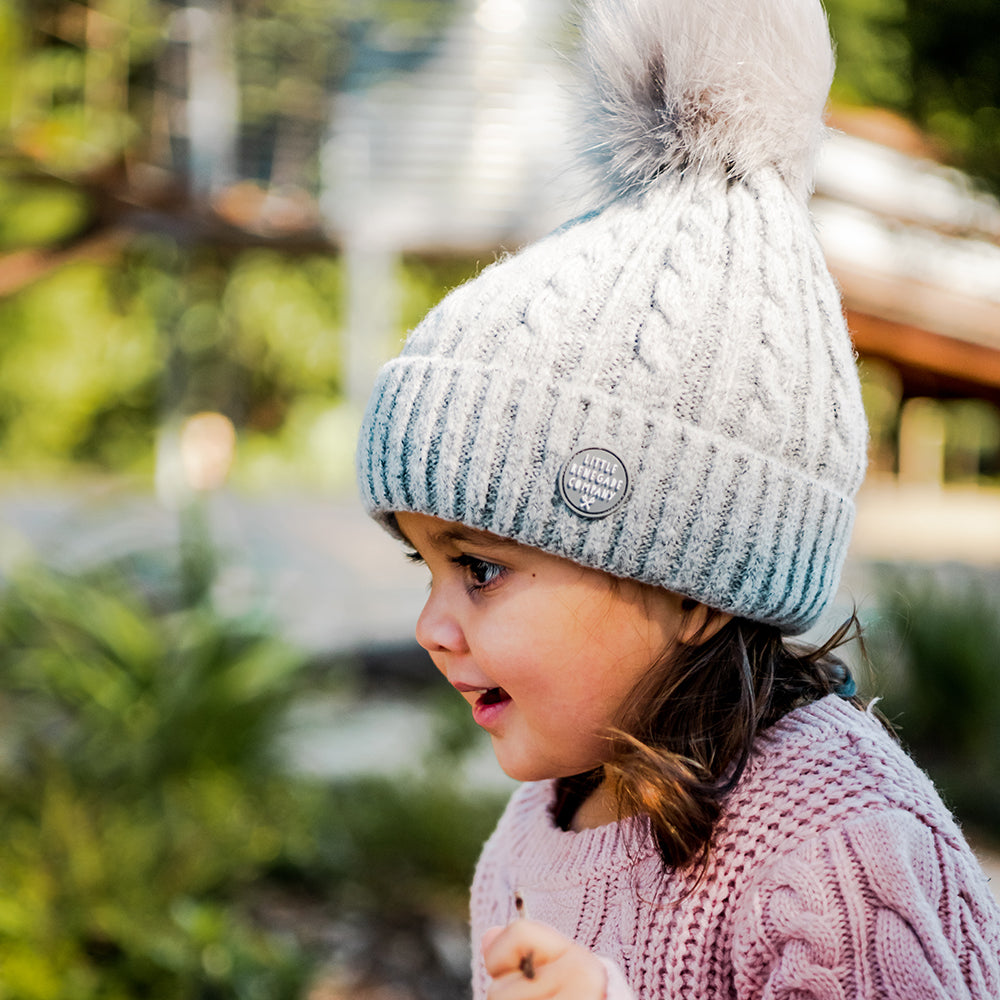Side view of a girl wearing the Grey Aurora Beanie outdoors