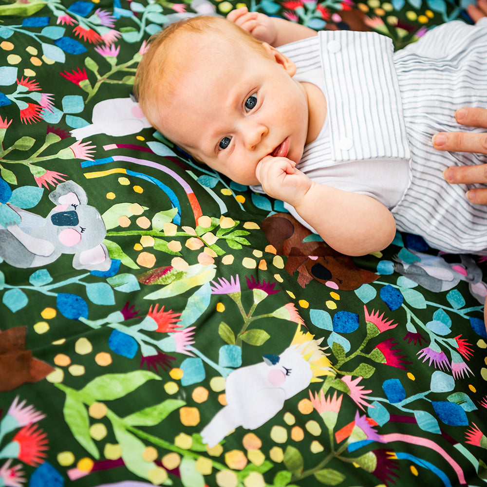 Baby lying on the Aussie Natives Adventure Mat outdoors