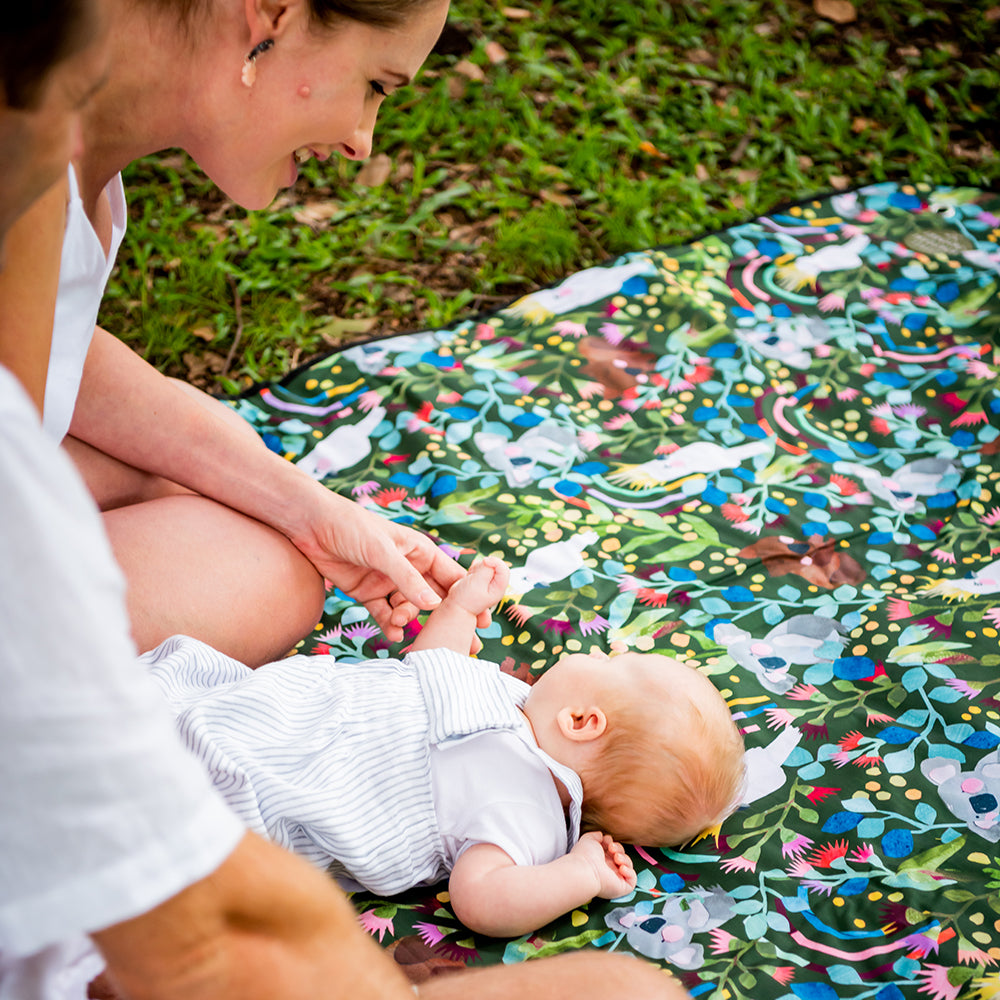 Baby lying on the Aussie Natives Adventure Mat outdoors