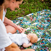 Parent and baby relaxing on the Aussie Natives Adventure Mat outdoors