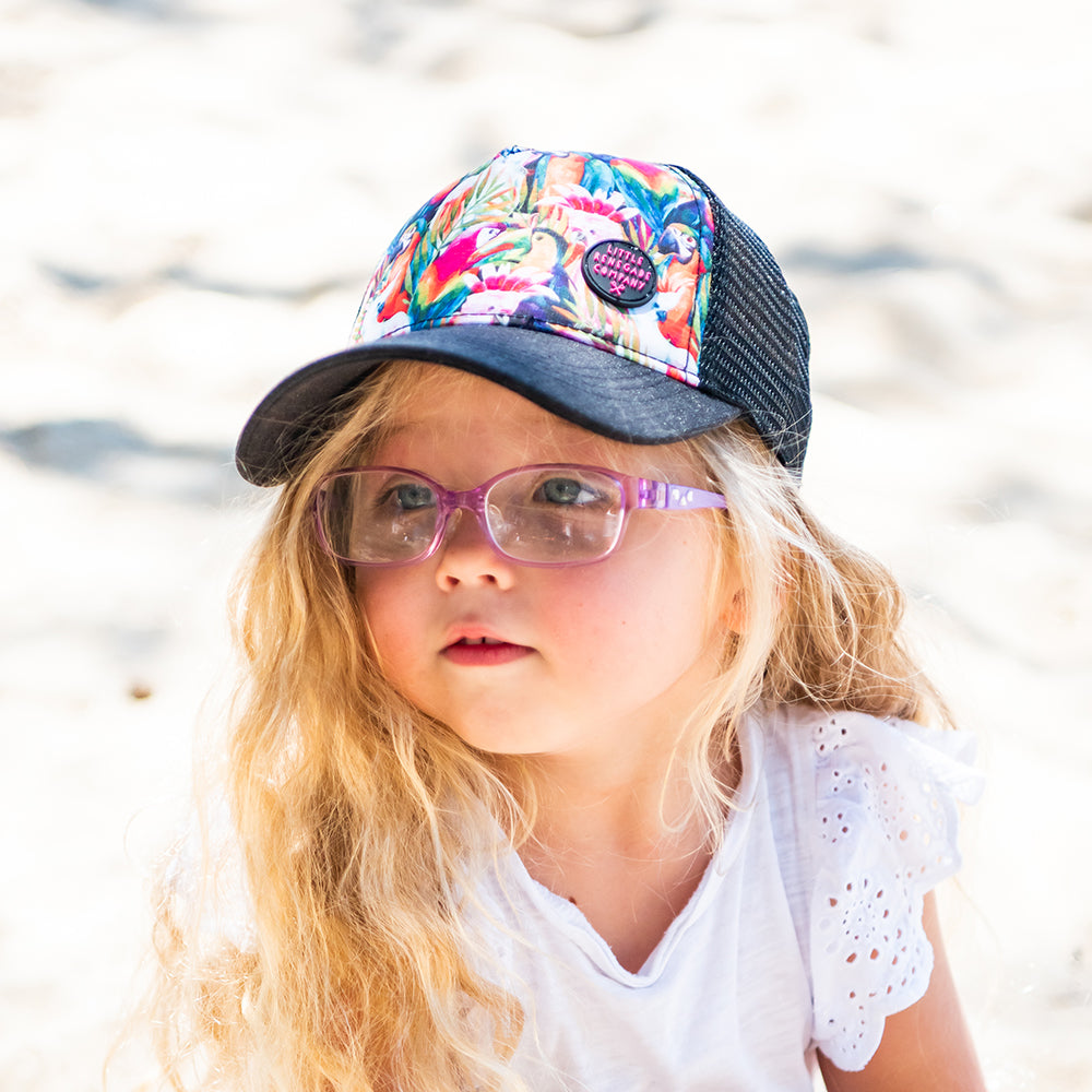 Child wearing the bright Flock Trucker Cap outdoors