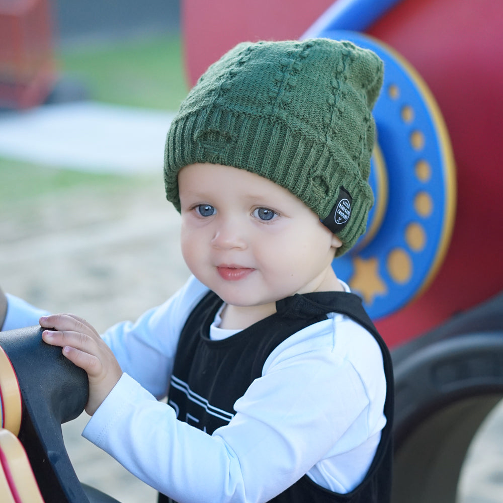 Child wearing the Olive Green Everest Beanie at the playground