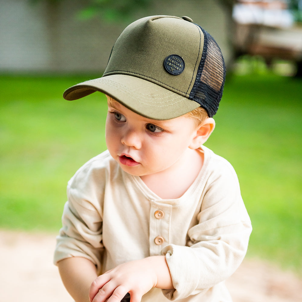 Child wearing the Hunter Trucker Cap during an everyday outdoor adventure