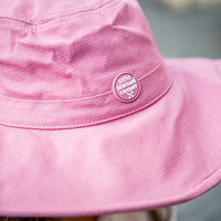Close-up of the Musk Sun Hat showing the linen texture, wide brim and Little Renegade patch
