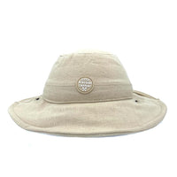 Oatmeal linen Sun Hat front view showing the wide wired brim and Little Renegade patch