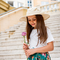 Girl wearing the Oatmeal Sun Hat outdoors on stairs