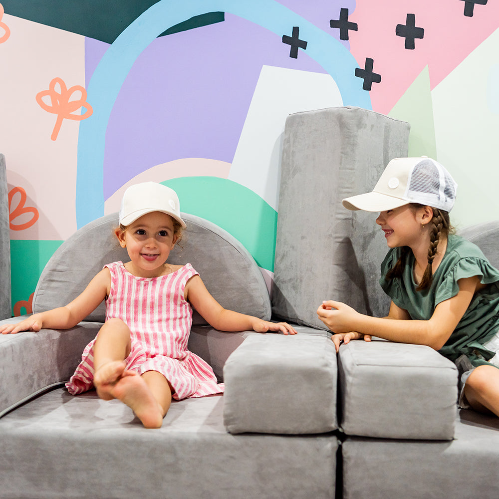 Child wearing the Wheat Trucker Cap during relaxed family play
