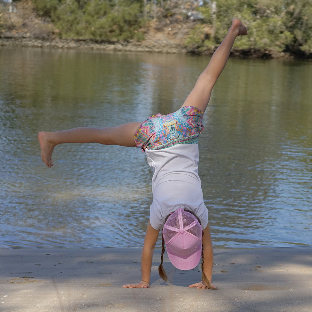 Child wearing the Blush Trucker Cap during an outdoor adventure
