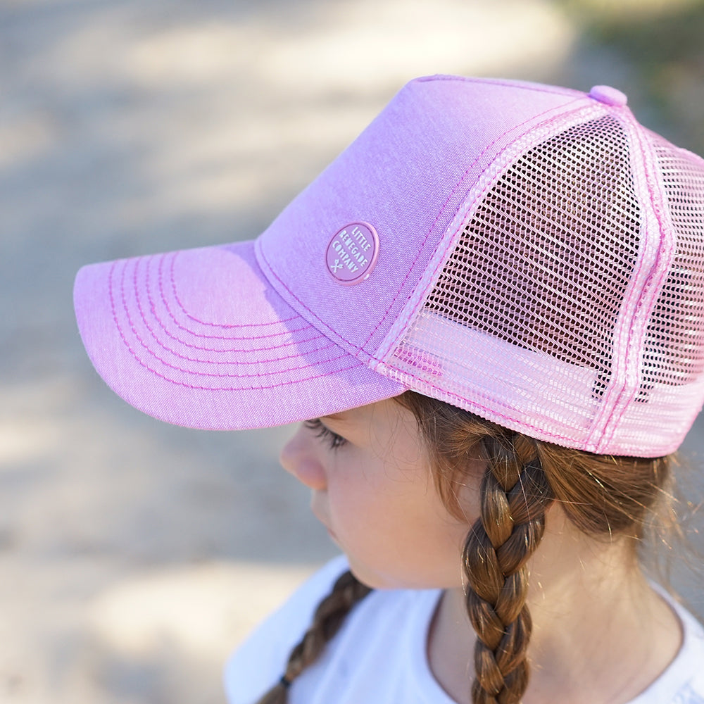 Child wearing the Blush Trucker Cap, showing the curved peak and breathable mesh